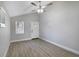 Bright bedroom featuring hardwood floors, fresh paint, and a front-facing window allowing natural light at 233 E Church Ave, Longwood, FL 32750