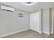Comfortable bedroom featuring modern ceiling fan, two large windows with shades, closet and neutral paint at 233 E Church Ave, Longwood, FL 32750