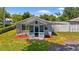 Inviting home with a quaint, screened porch, lovely landscaping, and a serene, fenced backyard at 233 E Church Ave, Longwood, FL 32750