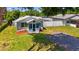 Charming home featuring a cozy, screened porch, nice landscaping, and a convenient gravel driveway at 233 E Church Ave, Longwood, FL 32750