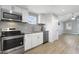 Well-appointed kitchen with stainless steel appliances and granite countertops seamlessly opens to a bright living area at 233 E Church Ave, Longwood, FL 32750