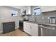 Well-equipped kitchen with stainless steel appliances, granite countertops, and stylish backsplash offers modern convenience at 233 E Church Ave, Longwood, FL 32750