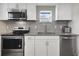 This newly renovated kitchen features stainless steel appliances, granite countertops, and ample storage space at 233 E Church Ave, Longwood, FL 32750