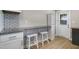 Modern kitchen area boasts granite countertops, ample cabinetry, and a cozy breakfast bar with seating for two at 233 E Church Ave, Longwood, FL 32750