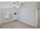Bright living room featuring hardwood floors, large window, ceiling fan, and neutral paint, perfect for relaxing or entertaining at 233 E Church Ave, Longwood, FL 32750