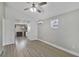 Bright living room featuring hardwood floors, white trim, high ceilings, and a view into the kitchen at 233 E Church Ave, Longwood, FL 32750