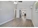 Bright and airy living room featuring hardwood floors, vaulted ceiling, and fresh white trim at 233 E Church Ave, Longwood, FL 32750
