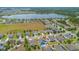 Aerial view of a home with a pool, solar panels, and a lake in the background at 2518 Hayden Valley St, Apopka, FL 32703