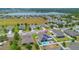 Aerial view of a home with a pool and solar panels in a lakeside community at 2518 Hayden Valley St, Apopka, FL 32703