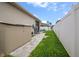 Side yard with stone pathway and view of the pool at 2518 Hayden Valley St, Apopka, FL 32703