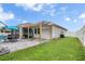 An outdoor patio area featuring a pergola, dining set, and view of the pool and grassy lawn at 2518 Hayden Valley St, Apopka, FL 32703