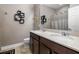 Bathroom with dual sinks, wooden cabinets, and modern fixtures at 2518 Hayden Valley St, Apopka, FL 32703
