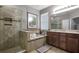 Elegant bathroom with a soaking tub, walk-in shower, and dual vanity sinks at 2518 Hayden Valley St, Apopka, FL 32703