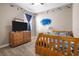 Bedroom with colorful underwater theme, dresser with television, and a ceiling fan at 2518 Hayden Valley St, Apopka, FL 32703