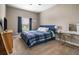 Bedroom with blue bed, soft carpet, and natural light from the window at 2518 Hayden Valley St, Apopka, FL 32703