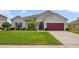 Well-maintained single-Gathering home with lush green lawn and colorful landscaping at 2518 Hayden Valley St, Apopka, FL 32703