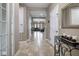 Spacious hallway featuring tile floors and views into the living spaces at 2518 Hayden Valley St, Apopka, FL 32703