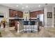 Kitchen with brown cabinets, a breakfast bar with seating, and a stainless steel refrigerator at 2518 Hayden Valley St, Apopka, FL 32703