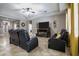Living room featuring tile floors, a ceiling fan, comfortable recliners, and a fireplace with a TV at 2518 Hayden Valley St, Apopka, FL 32703
