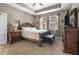 Main bedroom features a tray ceiling, carpet, and large bed with detailed headboard at 2518 Hayden Valley St, Apopka, FL 32703