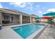 Backyard pool area with seating, colorful umbrellas and solar panels at 2518 Hayden Valley St, Apopka, FL 32703