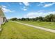 Expansive backyard with healthy lawn, paved path and a view of tranquil greenery at 2640 Shelby Ruth Pl, St Cloud, FL 34769