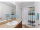 Well-lit bathroom featuring a shower-tub combo and vanity with ample counter space at 2640 Shelby Ruth Pl, St Cloud, FL 34769