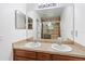 Double vanity bathroom showcasing dual sinks and access to a tiled shower at 2640 Shelby Ruth Pl, St Cloud, FL 34769