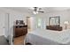 Serene bedroom with fan, dresser, and access to a private bath offering convenience at 2640 Shelby Ruth Pl, St Cloud, FL 34769
