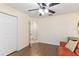 Well-lit bedroom with laminate floors, closet, and neutral paint colors at 2640 Shelby Ruth Pl, St Cloud, FL 34769