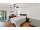 Bright bedroom with a ceiling fan, large bed, and a sliding glass door to the patio at 2640 Shelby Ruth Pl, St Cloud, FL 34769