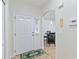 Welcoming entryway features tile flooring, white door and a view into the dining area, with a modern decor at 2640 Shelby Ruth Pl, St Cloud, FL 34769
