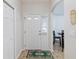 Bright entryway with white door, tile flooring, and a glimpse of the dining area, creating a welcoming ambiance at 2640 Shelby Ruth Pl, St Cloud, FL 34769