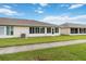 Back exterior view featuring enclosed sunroom, tidy lawn, and sidewalk path at 2640 Shelby Ruth Pl, St Cloud, FL 34769