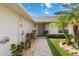 Pathway leads to a neutral-colored front door, complemented by lush landscaping and a well-kept lawn at 2640 Shelby Ruth Pl, St Cloud, FL 34769