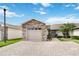Charming single-story home with a stone-accented facade and a well-manicured lawn with palm tree at 2640 Shelby Ruth Pl, St Cloud, FL 34769