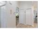 Hallway with tile flooring, multiple closets, and an arched doorway leading to a living room area at 2640 Shelby Ruth Pl, St Cloud, FL 34769