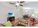 Spacious living room with hardwood floors, a large couch, and view of dining area, perfect for relaxing and entertaining at 2640 Shelby Ruth Pl, St Cloud, FL 34769