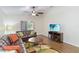 Bright living room featuring vaulted ceilings, ceiling fan, and sliding glass door to the outdoor spaces at 2640 Shelby Ruth Pl, St Cloud, FL 34769