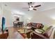 Open-concept living room with hardwood floors, a comfortable couch, and a view of the dining area at 2640 Shelby Ruth Pl, St Cloud, FL 34769