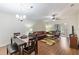 Open-concept living and dining area with hardwood floors, contemporary furnishings, and abundant natural light at 2640 Shelby Ruth Pl, St Cloud, FL 34769