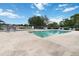Community pool surrounded by lounge chairs and a wrought iron fence on a sunny day at 2640 Shelby Ruth Pl, St Cloud, FL 34769