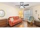 Relaxing sunroom with laminate floor, rocker chair, and natural light from a large window at 2640 Shelby Ruth Pl, St Cloud, FL 34769
