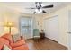Cozy sunroom with laminate floors, closet, and plenty of natural light from a bright window at 2640 Shelby Ruth Pl, St Cloud, FL 34769