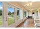 Bright sunroom with tiled floors, multiple windows, and an abundance of natural light at 2640 Shelby Ruth Pl, St Cloud, FL 34769