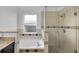 Bright bathroom features a soaking tub and a glass-enclosed shower, tiled in neutral colors at 2643 Alamosa Pl, Lake Mary, FL 32746