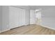 A brightly lit bedroom with wood floors and a closet with double doors at 2643 Alamosa Pl, Lake Mary, FL 32746