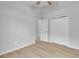 A brightly lit bedroom with wood floors and a closet with double doors at 2643 Alamosa Pl, Lake Mary, FL 32746
