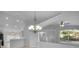 Bright living space with elegant chandelier, ceiling fan, and view to the pool at 2643 Alamosa Pl, Lake Mary, FL 32746