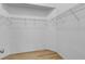 A walk-in closet features bright paint, bare shelving and laminate floors at 2643 Alamosa Pl, Lake Mary, FL 32746